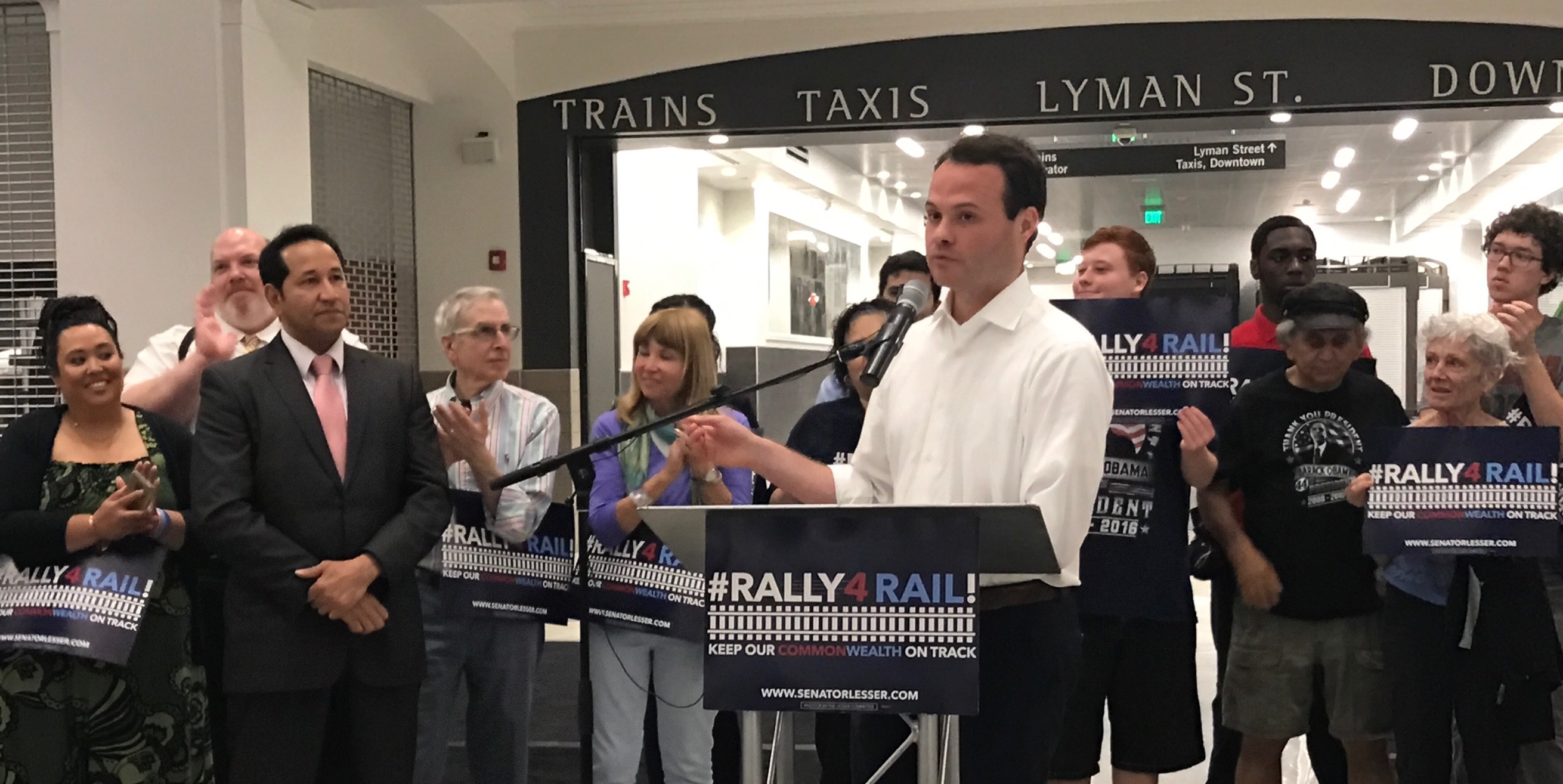 An image of Sen. Eric Lesser (D-MA) standing amongst a small crowd of individuals.